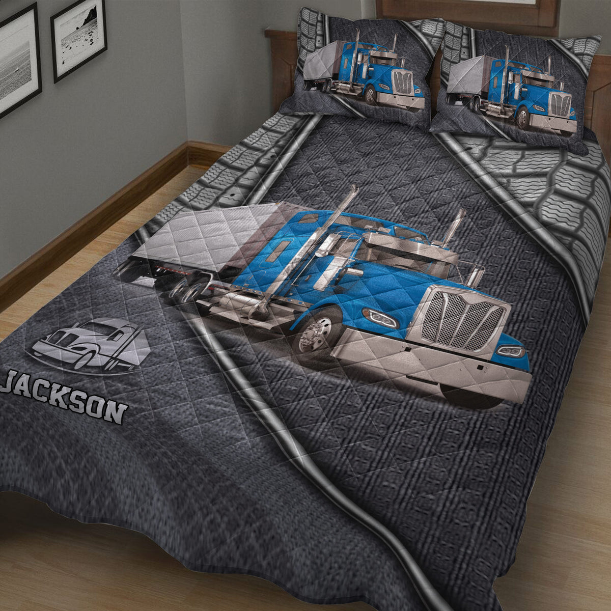 Close bedroom view of a trucker quilt blanket with blue semi truck artwork and matching truck-themed pillowcases