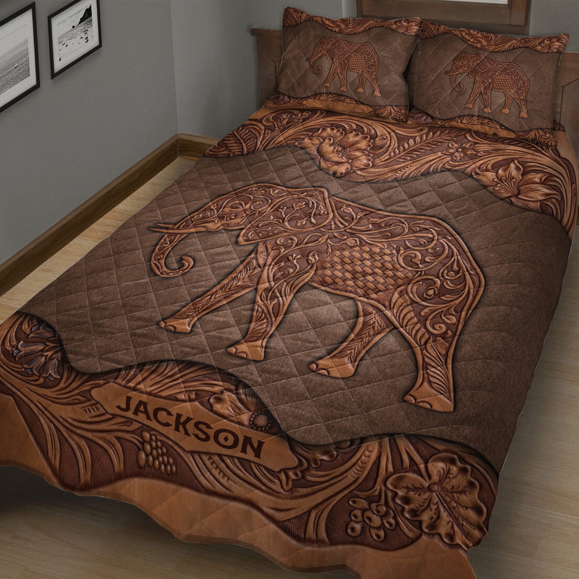 Close bedroom view of an ornate elephant quilt blanket with brown floral and paisley artwork