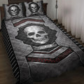 Skull quilt blanket spread across a bed with bold black, gray, and red armor-inspired artwork