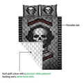 Skull quilt blanket showing the printed front and white quilted backing in a construction detail view