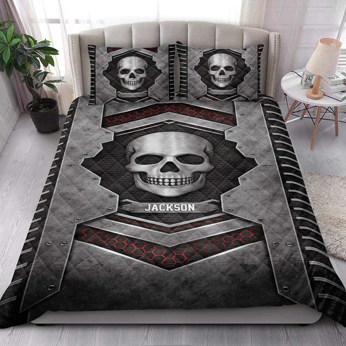 Skull quilt bedding set styled on a bed with dramatic black, gray, and red gothic artwork
