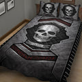 Close lifestyle view of a skull quilt blanket featuring metallic gray panels and red geometric accents