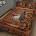 Close bedroom view of a mallard duck quilt blanket with rustic woven texture and decorative floral scrollwork