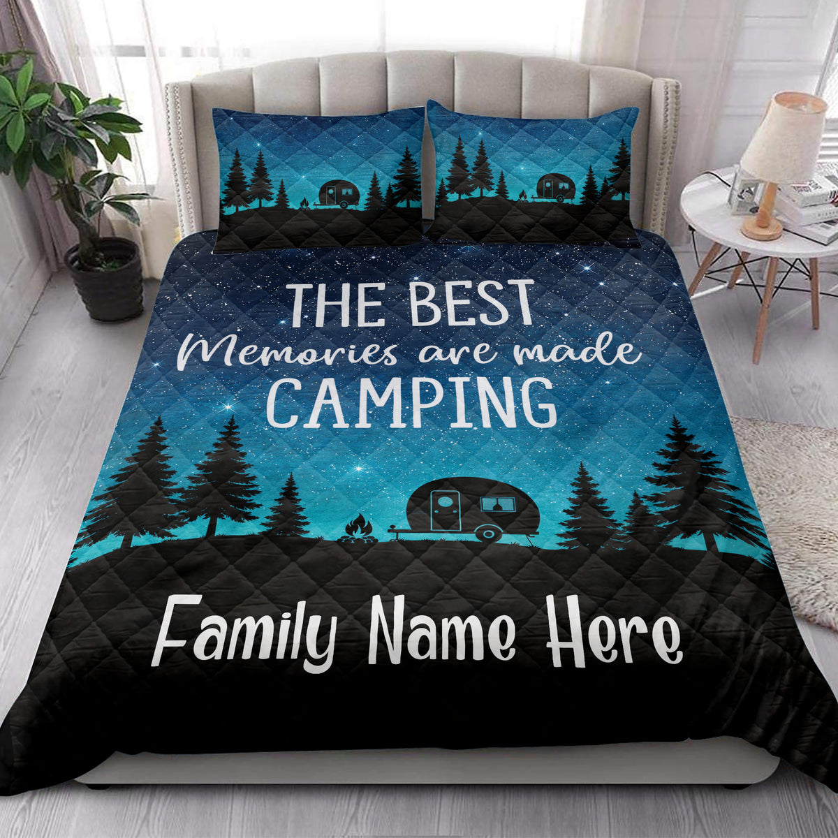 Camping quilt bedding styled in a bright bedroom with starry sky, pine trees, and camper trailer design