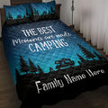 Camping quilt blanket on a bed with turquoise starry sky, pine trees, camper artwork, and family design theme