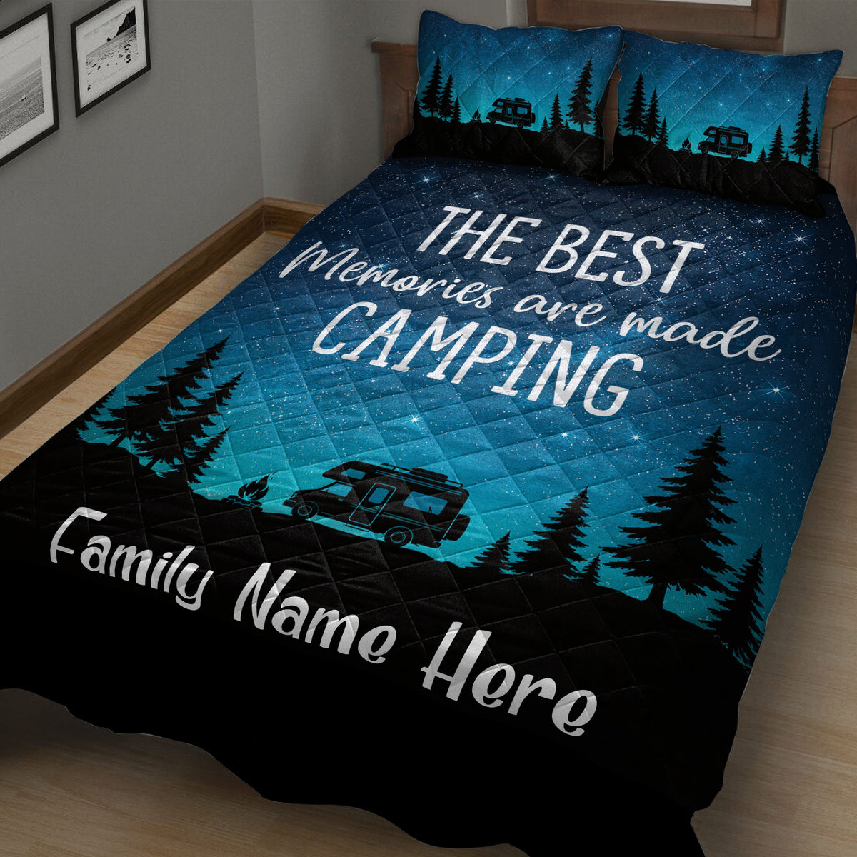 Angled bedroom view of a camping quilt blanket with camper, pine forest, campfire, and starry night artwork