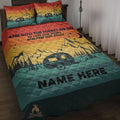 Camping quilt blanket displayed on a bed with mountain, pine forest, travel trailer, moon, stars, and campfire artwork