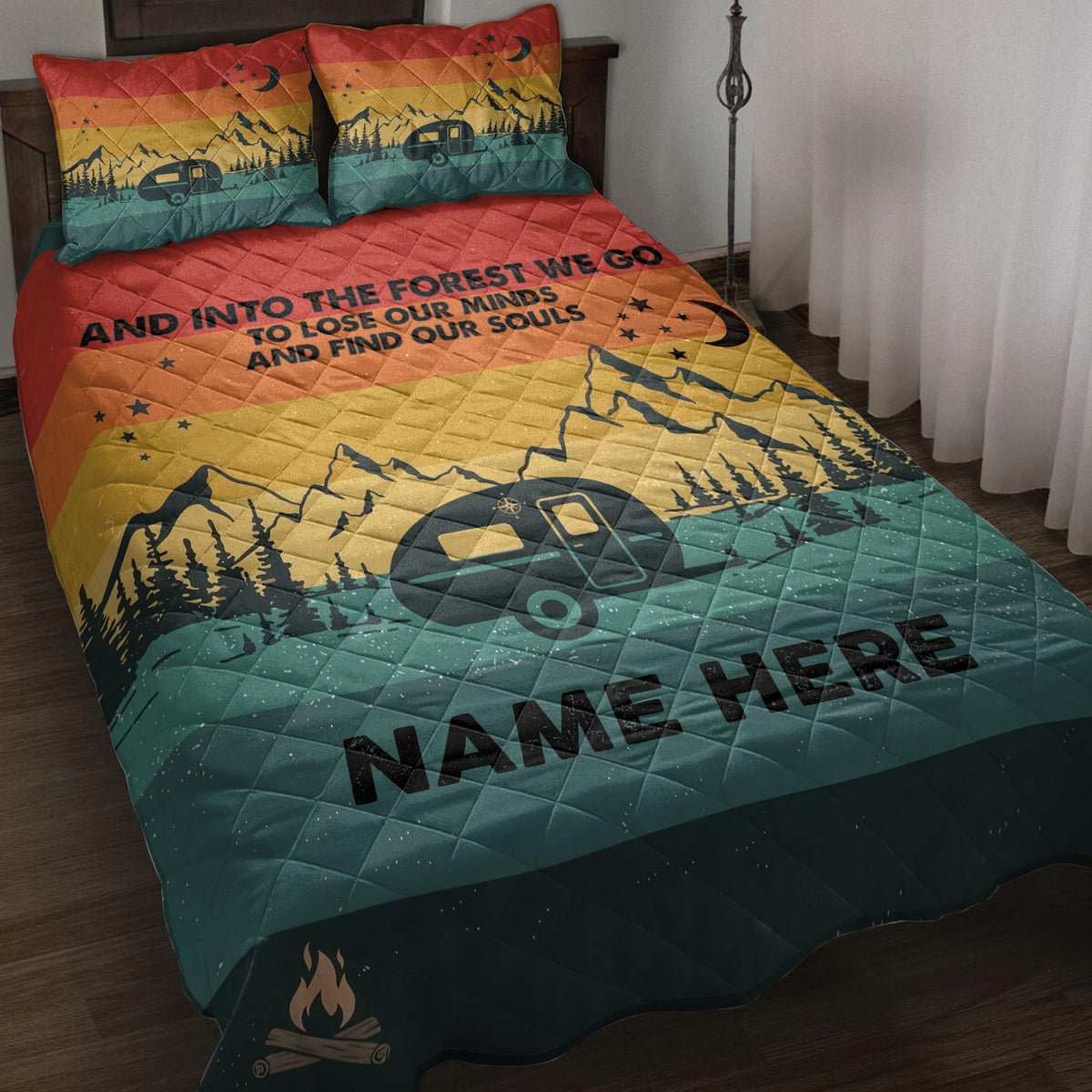 Camping quilt blanket displayed on a bed with mountain, pine forest, travel trailer, moon, stars, and campfire artwork