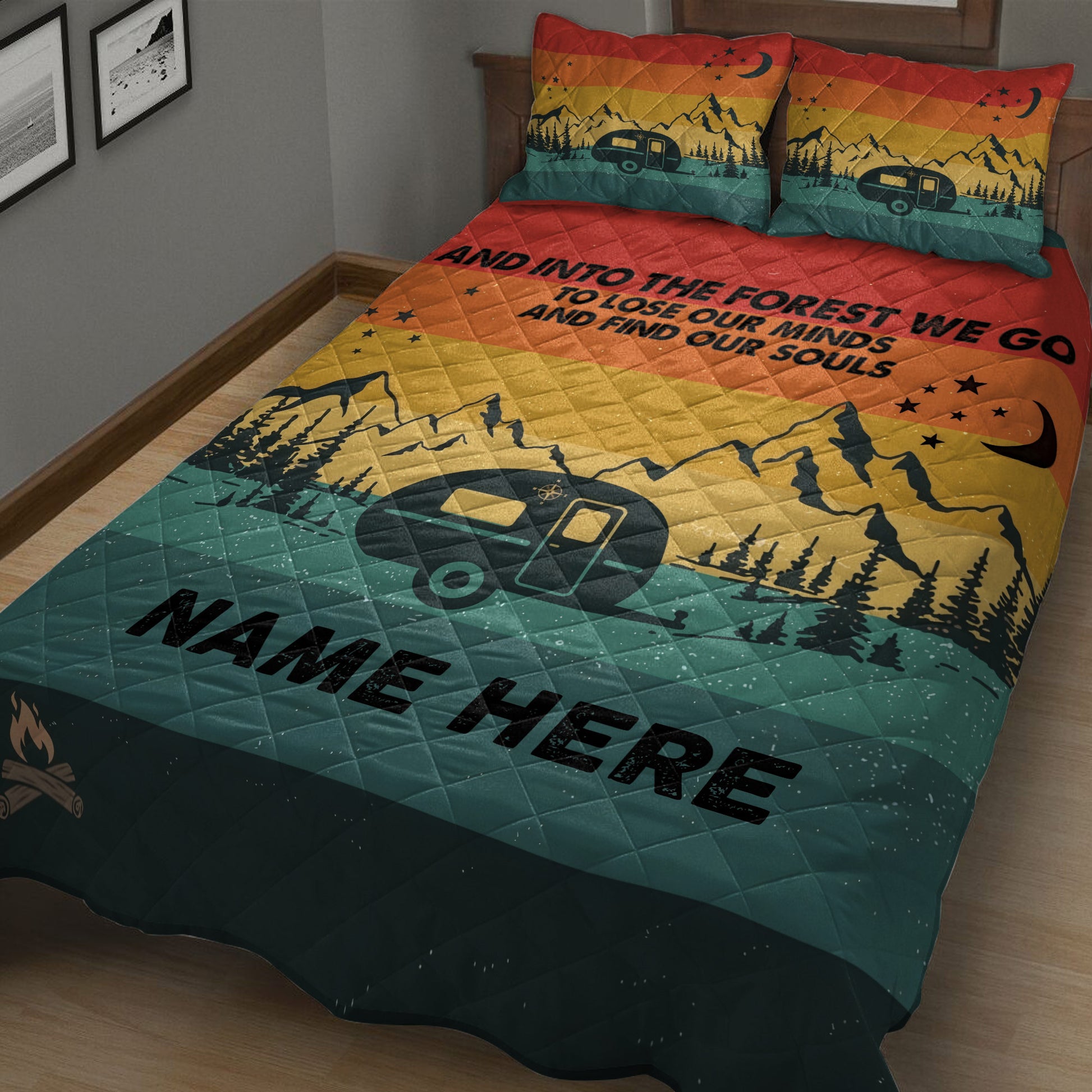 Close view of camping quilt bedding with colorful mountain scenery, travel trailer, pine trees, and night sky details