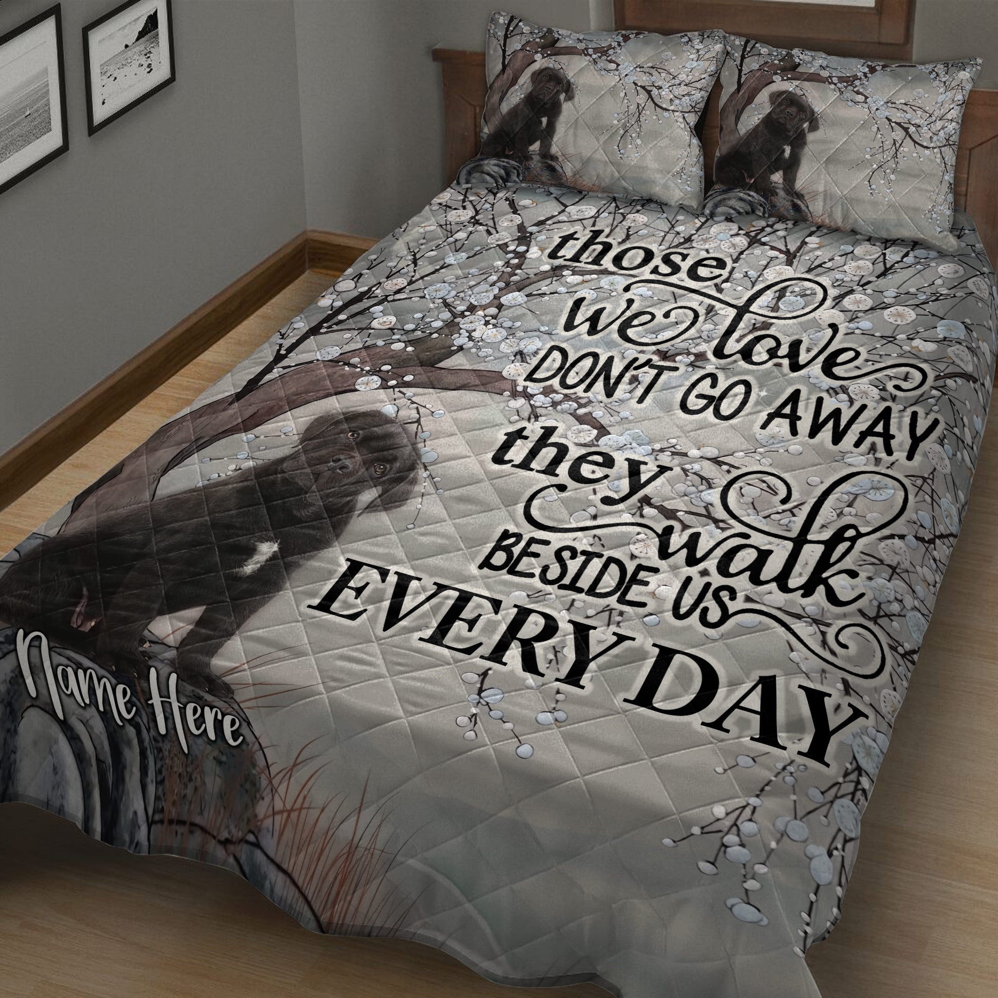 Close view of Cane Corso quilt bedding with dark dog portrait, blossoming branches, and gray tones