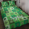Irish shamrock quilt blanket displayed on a bed with green checkerboard squares and decorative clovers