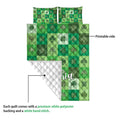 Irish shamrock quilt detail showing the printed green clover side and white quilted reverse backing