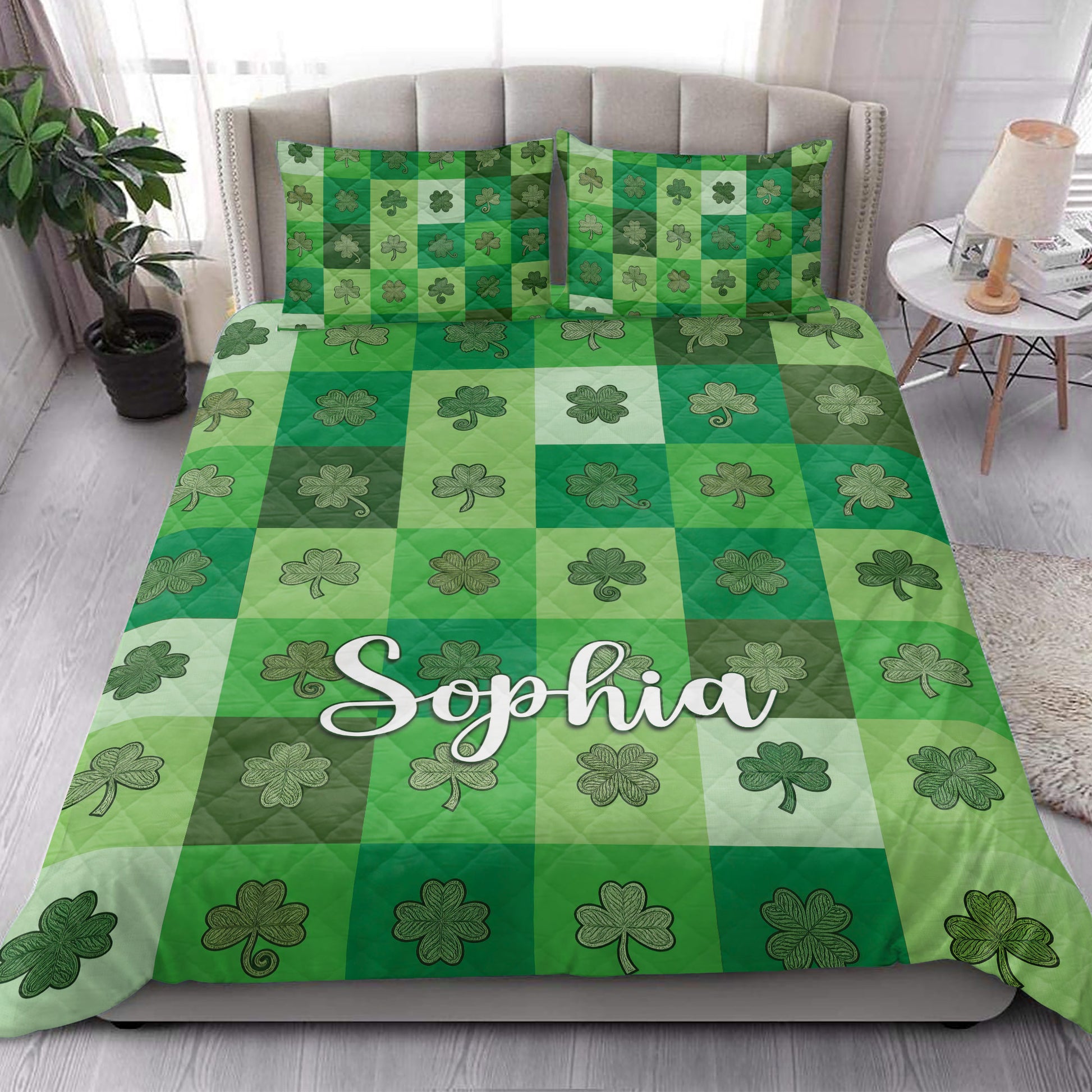 Irish shamrock quilt blanket styled on a bedroom bed with green checkerboard clover artwork
