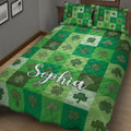 Close bedroom view of an Irish shamrock quilt blanket with layered green squares and clover motifs