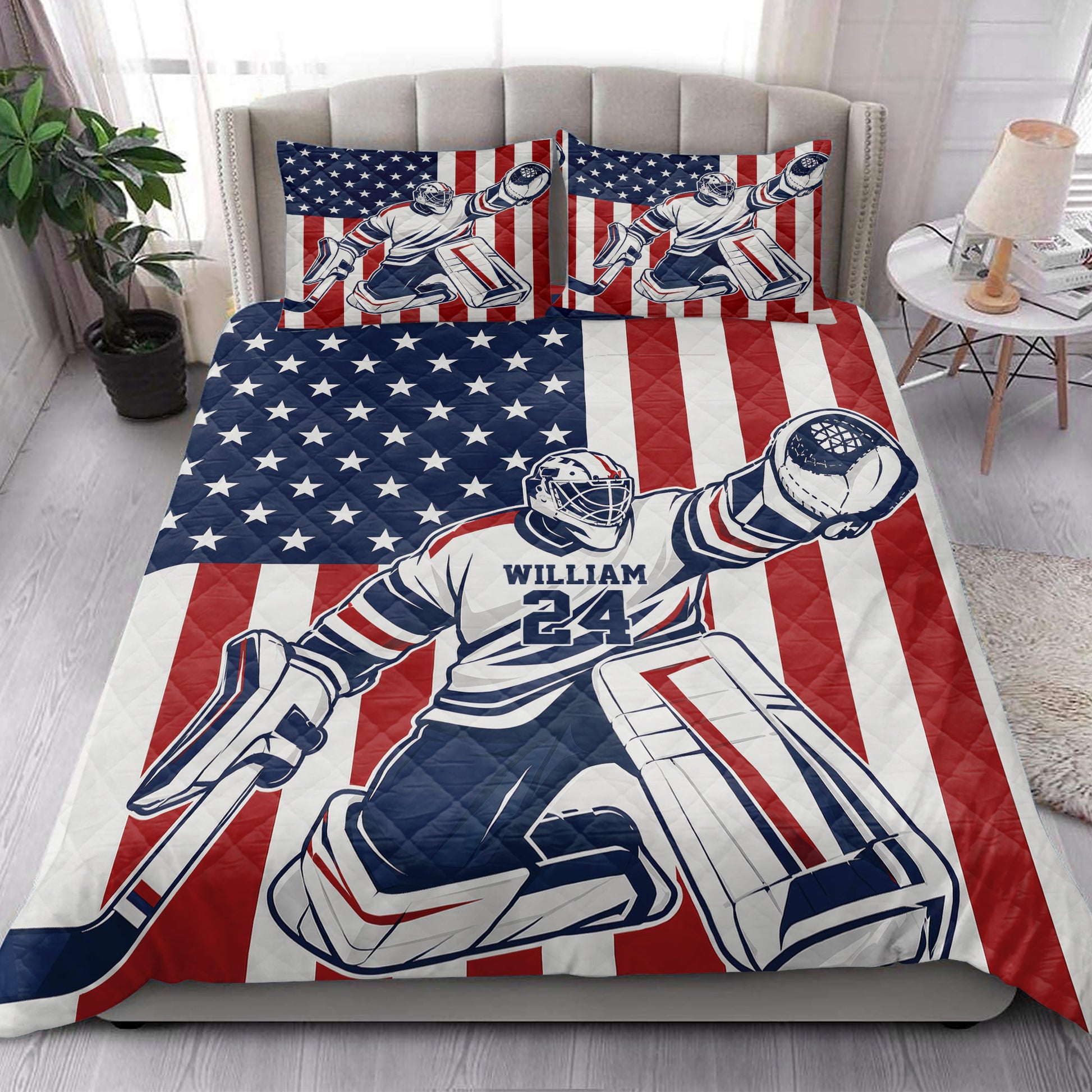 Hockey quilt bedding styled in a bright bedroom with goalie artwork and red, white, and blue patriotic design