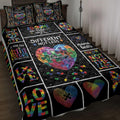 Autism awareness quilt blanket displayed on a bed with colorful puzzle-piece hearts and neurodiversity artwork