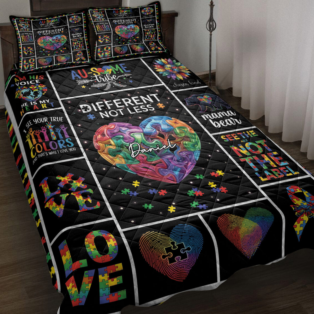 Autism awareness quilt blanket displayed on a bed with colorful puzzle-piece hearts and neurodiversity artwork
