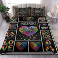 Autism awareness quilt blanket styled in a bright bedroom with colorful puzzle-piece and heart artwork