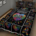 Close view of autism awareness quilt bedding with colorful puzzle pieces, hearts, ribbon, and acceptance artwork