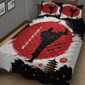 Close bedroom view of a karate quilt with kicking martial artist silhouettes and pagoda artwork