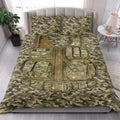 Camouflage military-themed quilt blanket styled across a bedroom with tactical vest artwork
