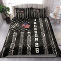 Racing quilt bedding styled in a bright bedroom with checkered flags, tire tracks, and bold black and white artwork