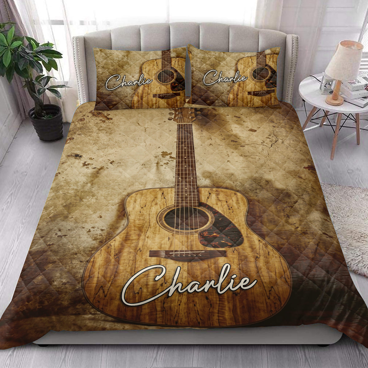 Acoustic guitar quilt blanket styled on a bright bedroom bed with matching guitar artwork