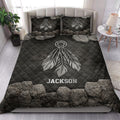 American Native dreamcatcher quilt blanket styled on a modern bed with matching dark feather pillows