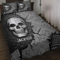 Black and gray skull quilt blanket styled on a bed with star patterns and bold gothic artwork