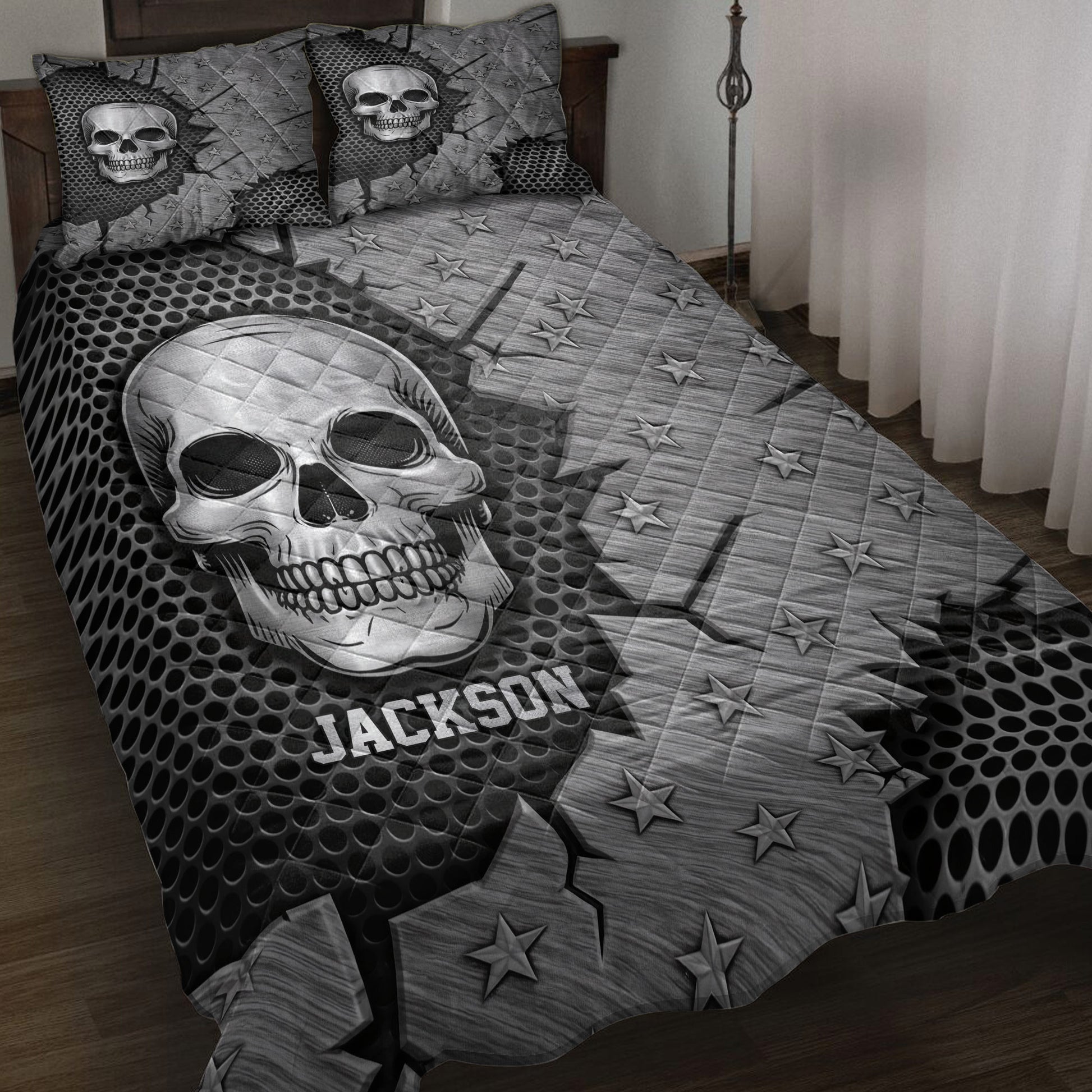 Black and gray skull quilt blanket styled on a bed with star patterns and bold gothic artwork