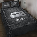 Black camping quilt blanket displayed on a bed with silver travel trailer artwork and chain details