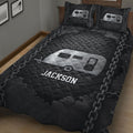 Black RV camping quilt blanket displayed in a bedroom with silver trailer artwork