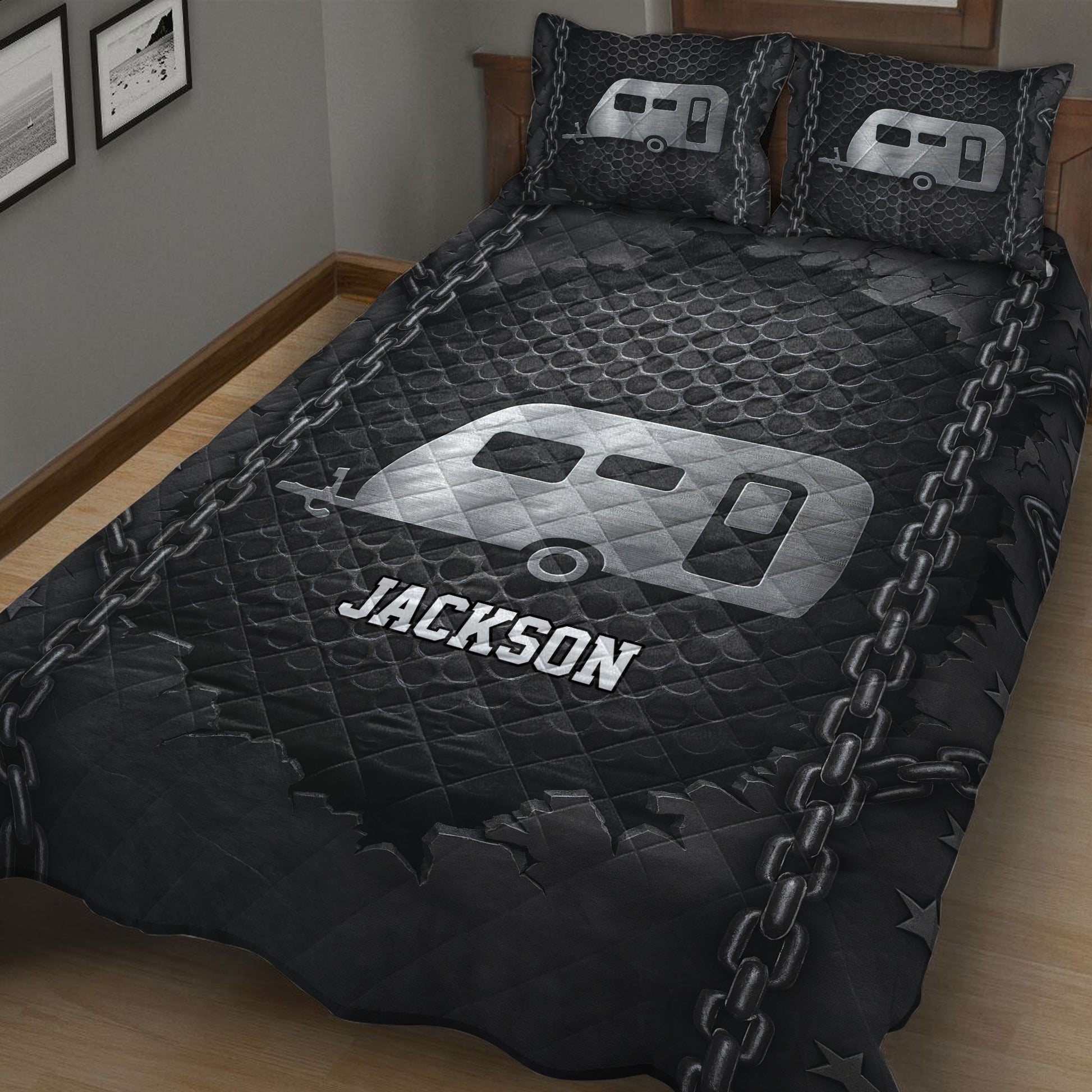 Black RV camping quilt blanket displayed in a bedroom with silver trailer artwork