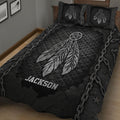 Black Native American quilt blanket displayed on a bed with large silver feathers and dreamcatcher artwork