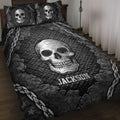 Black skull quilt blanket displayed on a bed with chain borders, cracked textures, and gothic artwork