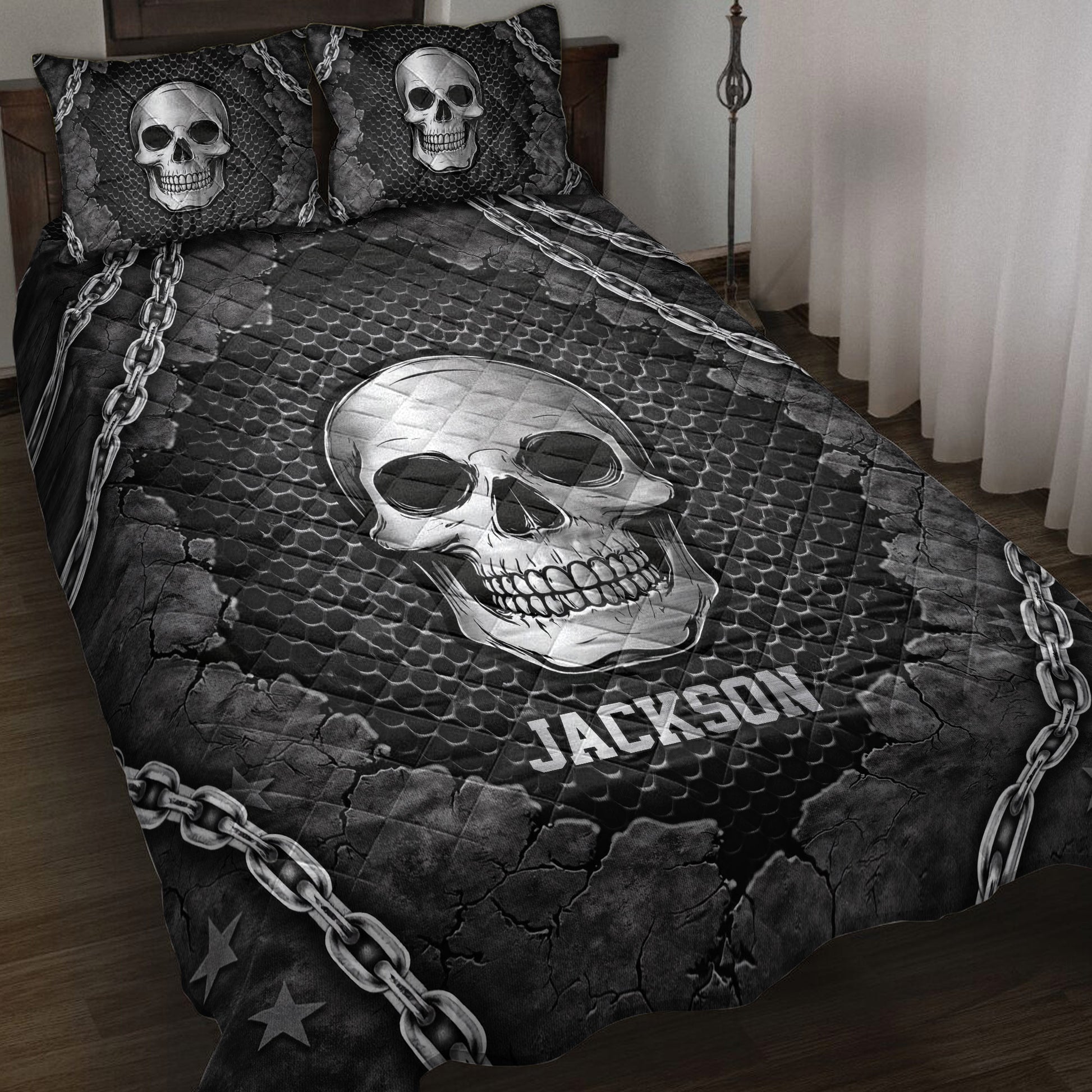 Black skull quilt blanket displayed on a bed with chain borders, cracked textures, and gothic artwork