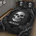 Black and gray skull quilt blanket displayed on a bed with chains, cracked textures, and bold gothic artwork