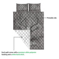 Hunting quilt showing deer skull and antler artwork with a white quilted backing