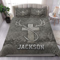 Hunting quilt blanket styled in a bright bedroom with large antlers and rustic outdoor artwork
