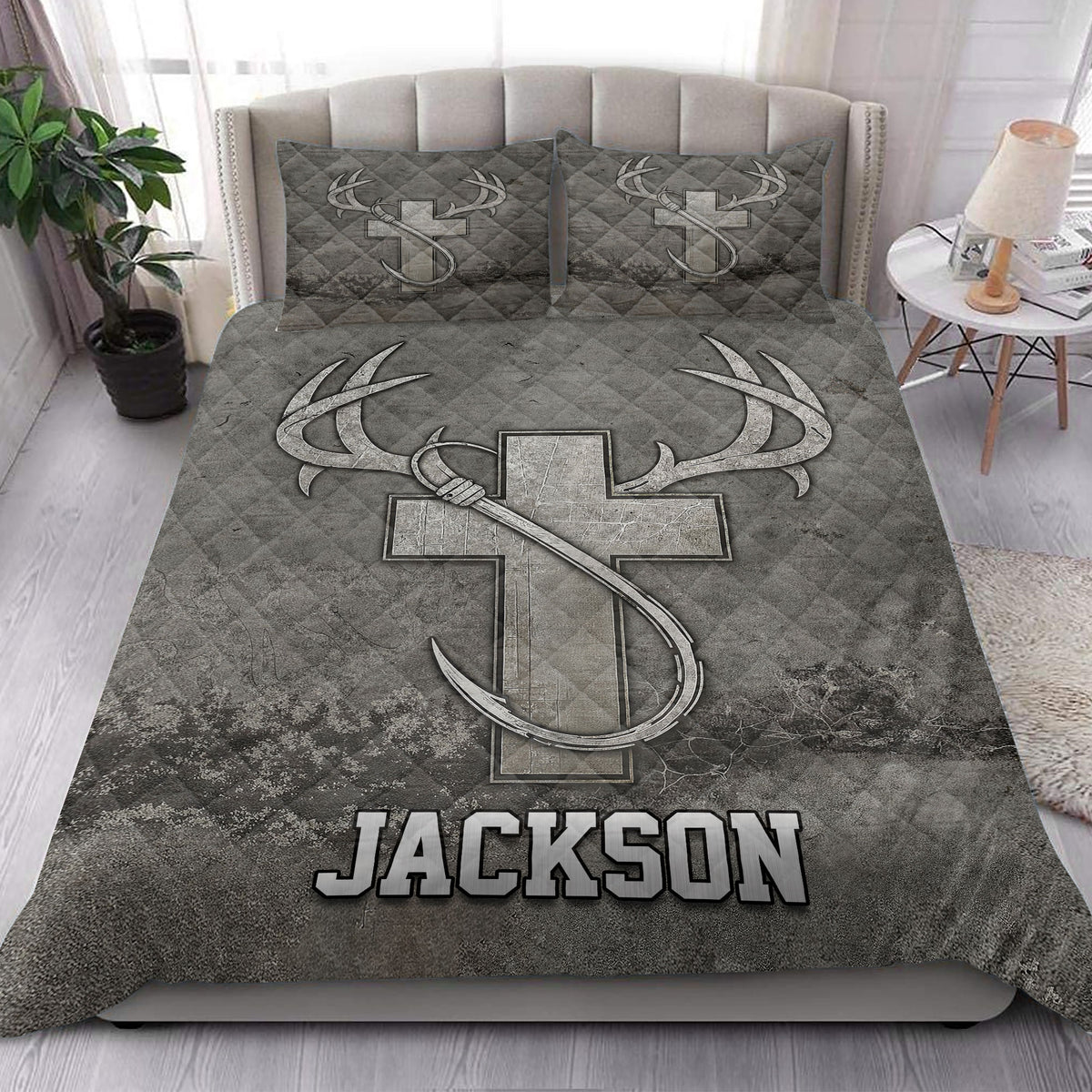 Hunting quilt blanket styled in a bright bedroom with large antlers and rustic outdoor artwork