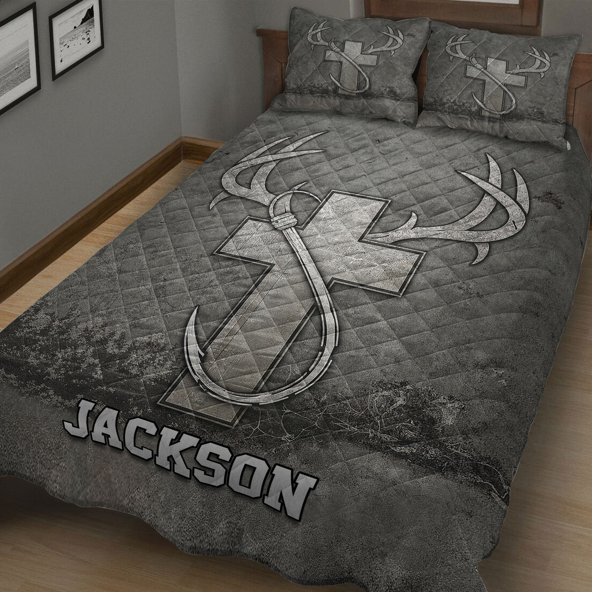 Rustic hunting quilt spread across a bed with antlers, woodland scenery, and dark gray artwork