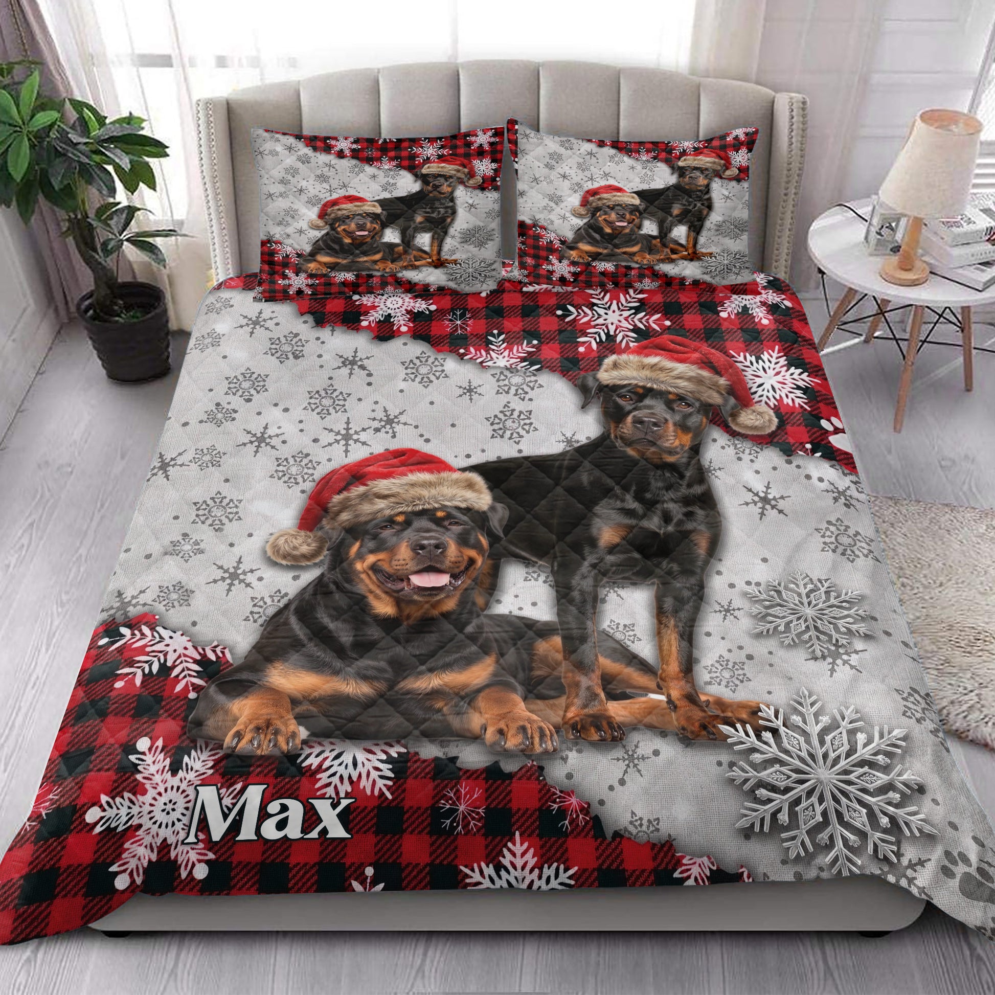 Rottweiler Christmas quilt styled on a bedroom bed with snowy plaid artwork