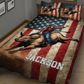 Patriotic rodeo quilt blanket featuring a cowboy riding a bucking bull on a bed