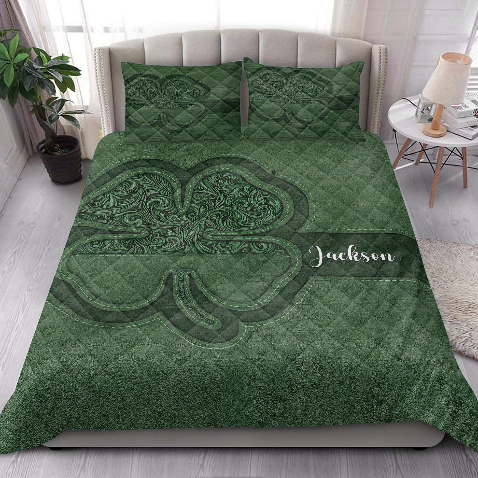 Irish shamrock quilt blanket styled in a bright bedroom with deep green Celtic-inspired artwork