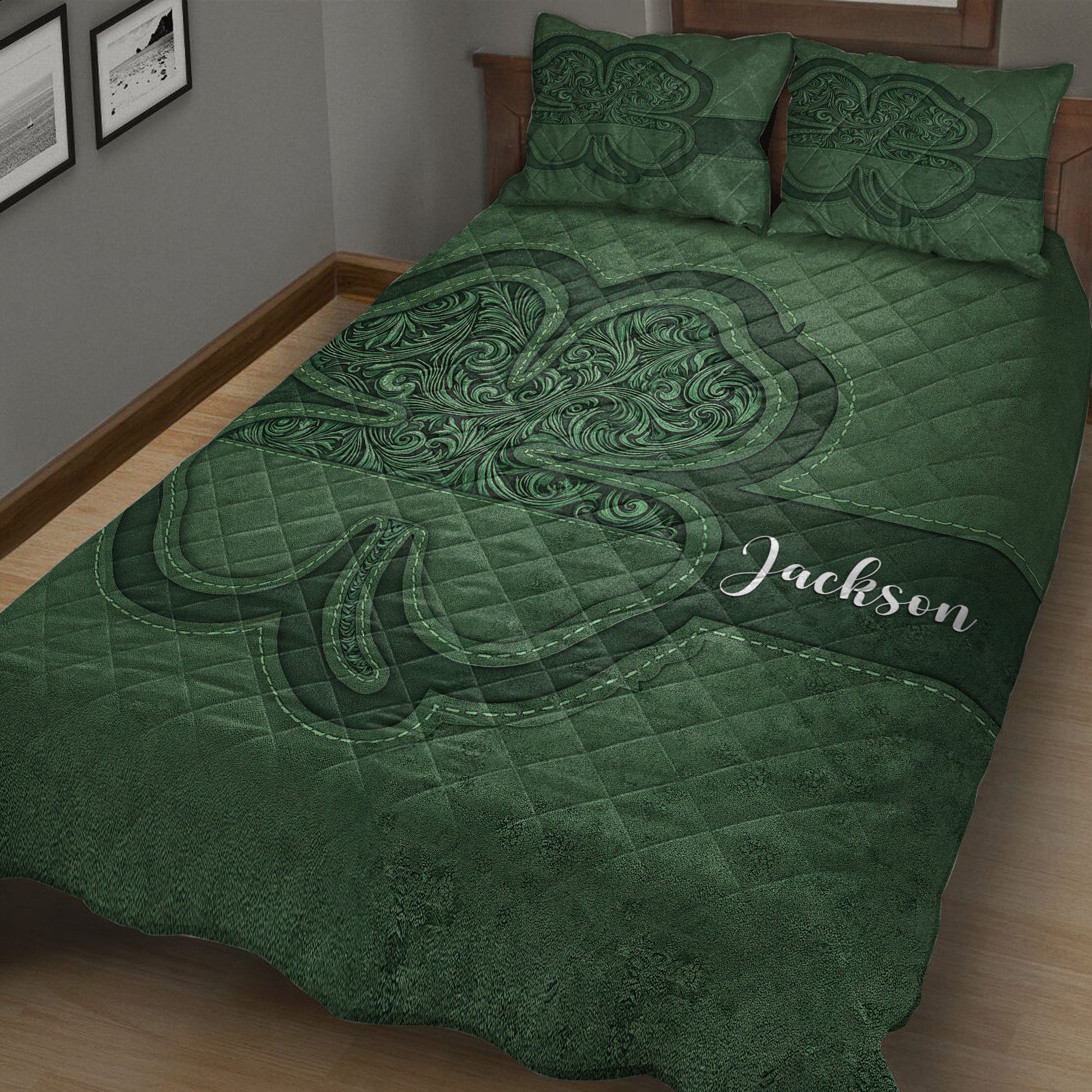 Close bedroom view of a deep green Irish shamrock quilt blanket with ornate swirling details