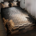 Chess quilt blanket styled on a bed with black and gold chess pieces and a dramatic checkerboard design