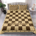 Chessboard quilt bedding set styled in a bright bedroom with matching pillows and warm wood tones