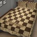 Close bedroom view of a brown and tan chessboard quilt blanket with matching pillow designs
