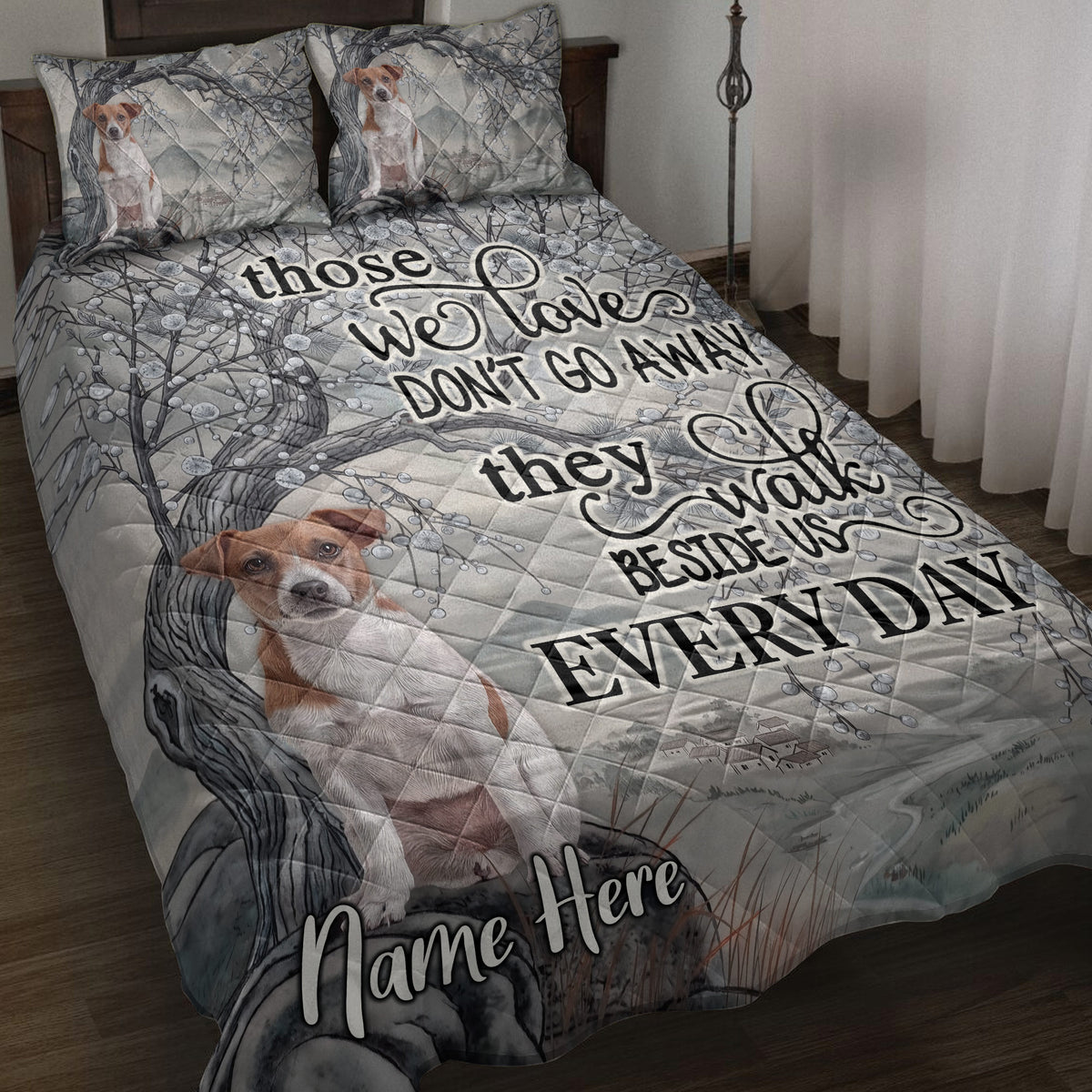 Jack Russell dog quilt blanket displayed on a bed with woodland branches, landscape artwork, and heartfelt typography