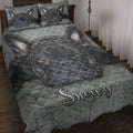 French Bulldog quilt blanket displayed on a bed with a large black Frenchie portrait and gray cracked-stone artwork